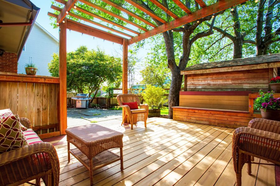 Backyard Deck With Wicker Furniture And Pergola.