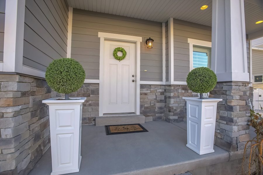 Home With Wreath On The Door And A Combination Of Wood And Stone