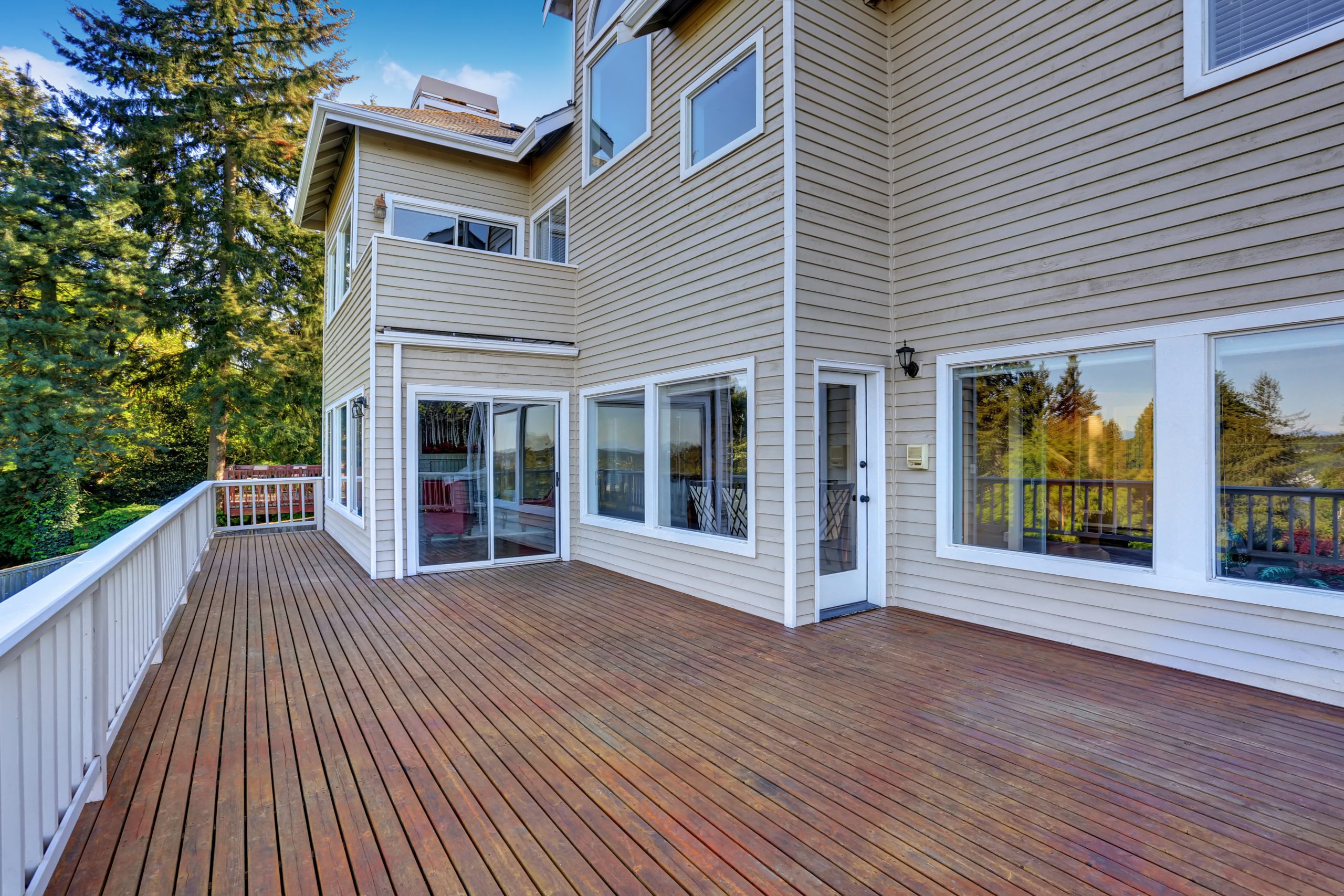 Two Story House With Wooden Walkout Deck Overlooking Backyard Ga