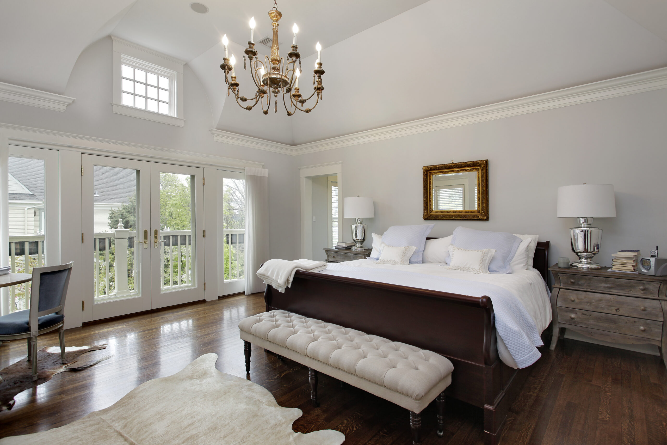 Master Bedroom In Luxury Home With Doors To Balcony.